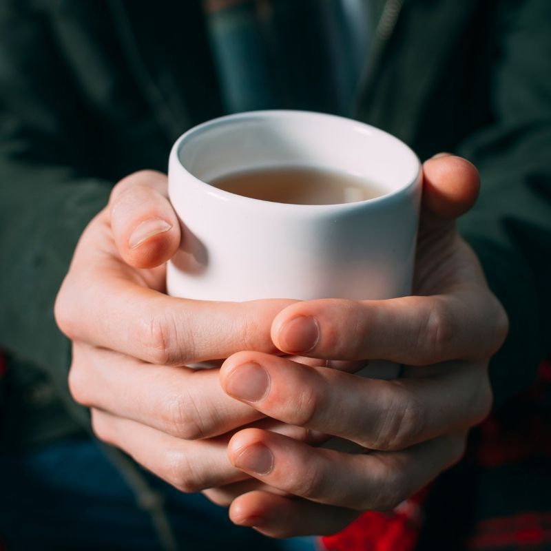 Hands holding a mug of coffee