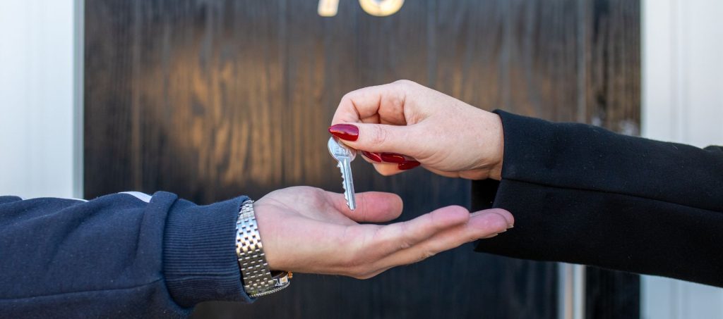 hand holding out a key