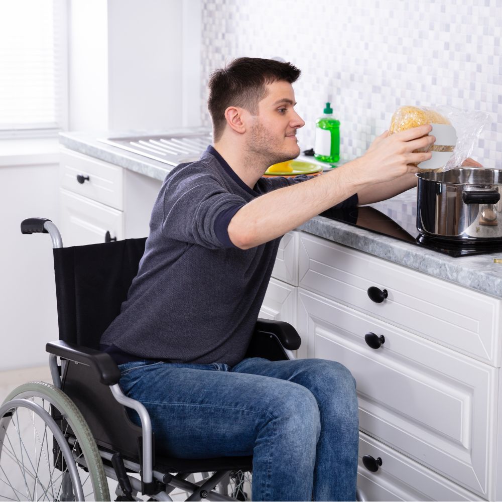 Wheelchair user putting pasta in a pot